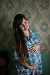 Portrait of a young beautiful pregnant girl