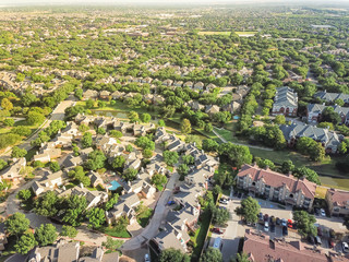 Aerial view apartment complex building and residential houses with canal river separator. Green and...