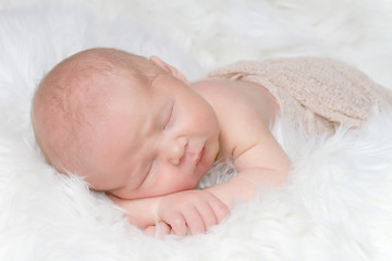 sleeping newborn baby on a blanket