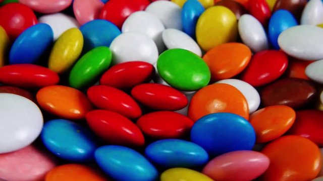 Multicolored candy, dragee on a plate, close-up.