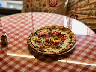 Sicilian Pizza with Onion Rings, Pesto and Garlic Sauce served on Red Tablecloth