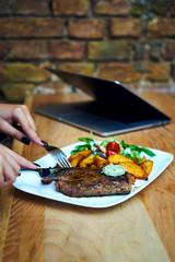 a business girl eats a steak at a restaurant