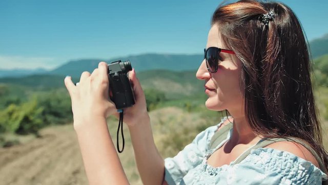 Close up portrait female traveler taking picture of nature using camera
