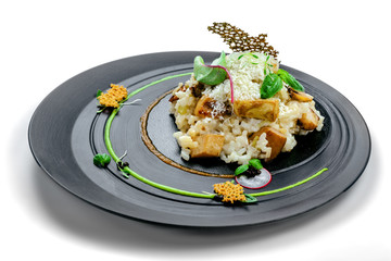 Classic Italian risotto cooked in a vegetable broth with porcini mushrooms and parmesan isolated on white background. Delicious vegetarian Italian cuisine rice meal.