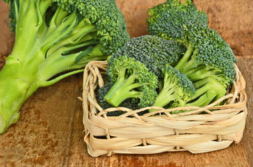 healthy and benefits of Broccoli. .a lot of broccoli in basket on wooden background.