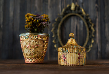 Vintage caskets  on a wooden background and antique bronze frame