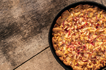 Homemade apple pie on wooden background. Place for text.