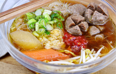 Thai street food Beef ball and thin rice noodles with dark soup.