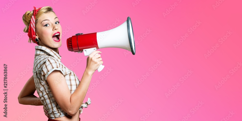 Wall mural portrait of woman holding megaphone, dressed in pin-up style