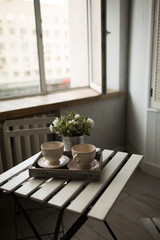 Two cups of tea or coffee on table at morning in loft interior