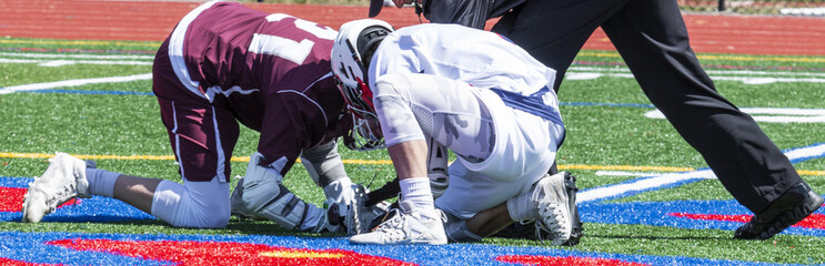 High school boys faceoff in lacrosse