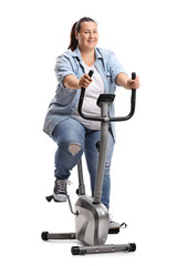 Overweight woman exercising on a stationary bike