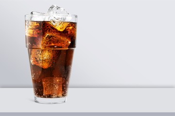 Glass of cola with ice cubes isolated on white background