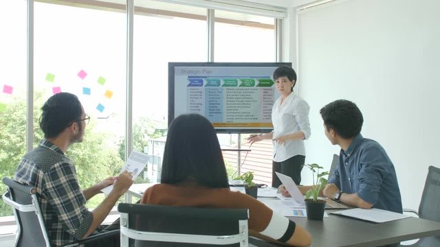 Business presentation. Attractive young business woman making presentation to her colleagues in the conference room.