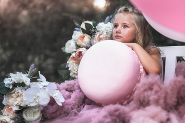 Cute little girl holds French Macaron. Confectionery concept