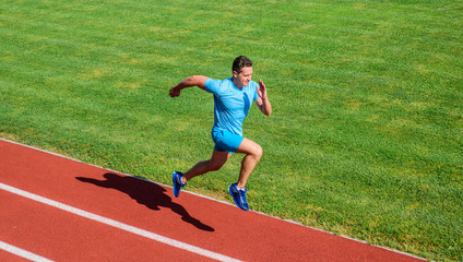 Run into shape. Running challenge for beginners. Athlete run track grass background. Sprinter training at stadium track. Runner captured in midair. Short distance running challenge. Boost speed