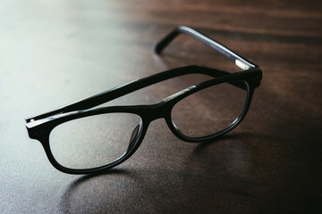 Black Spectacle on wooden table