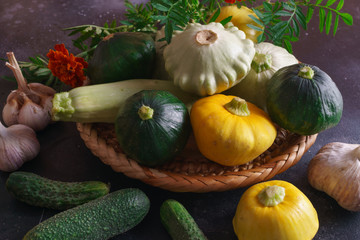 Different vegetables, small patissons, along with other vegetables, cauliflower, broccoli, garlic, cucumbers grown on an eco-farm