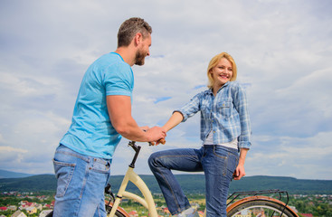 Rolling romance or bike date. Man with beard and shy blonde girl on first date. Woman feels shy in company with attractive macho. Couple just meet to hang out together. Сasual acquaintance concept