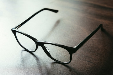 Black Spectacle on wooden table