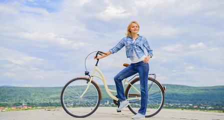 Benefits of cycling every day. Girl ride cruiser bicycle. Health benefits of cycling. Reasons to ride bike. Woman rides bicycle sky background. Increase muscle strength and flexibility by riding bike