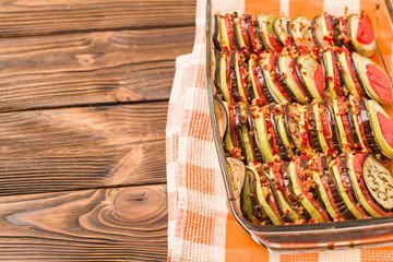 Ratatouille close up photography with fresh cooked vegetarian meal on brown wooden background with...