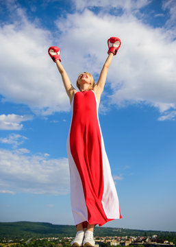 Femininity and strength balance. Woman red dress and boxing gloves enjoy victory. She fighter female rights. Lady fighter enjoy celebrate victory. Satisfied free girl boxing gloves. Winner concept
