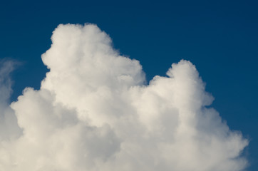 Beautiful cumulus clouds iand sunlight in a blue summer sky