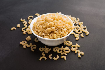 Plate of gluten free pasta on black background