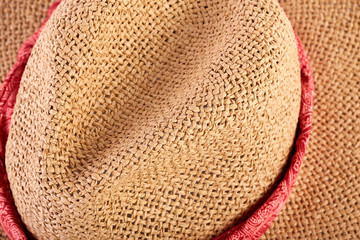 Fototapeta na wymiar Wicker straw flaxen hat with red ribbon on isolated white background. Fashion accessory. Female summer hat.