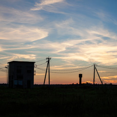 Sunset in a field with a transformer box