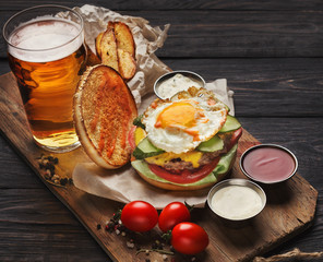 Burger and potatoes served with beer at restaurant