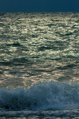 sea landscape is a pebbly beach with waves in white foam