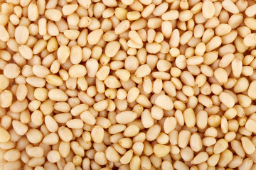 Peeled pine nuts on a white background. Healthy food. Nuts.