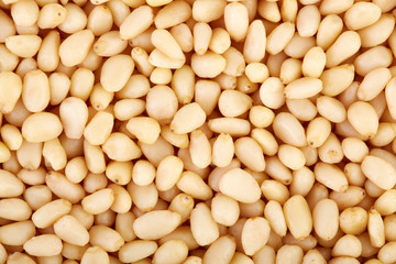 Peeled pine nuts on a white background. Healthy food. Nuts.