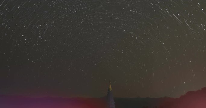 view of asian buddhist pagoda and startrail in galaxy universe (time lapse)