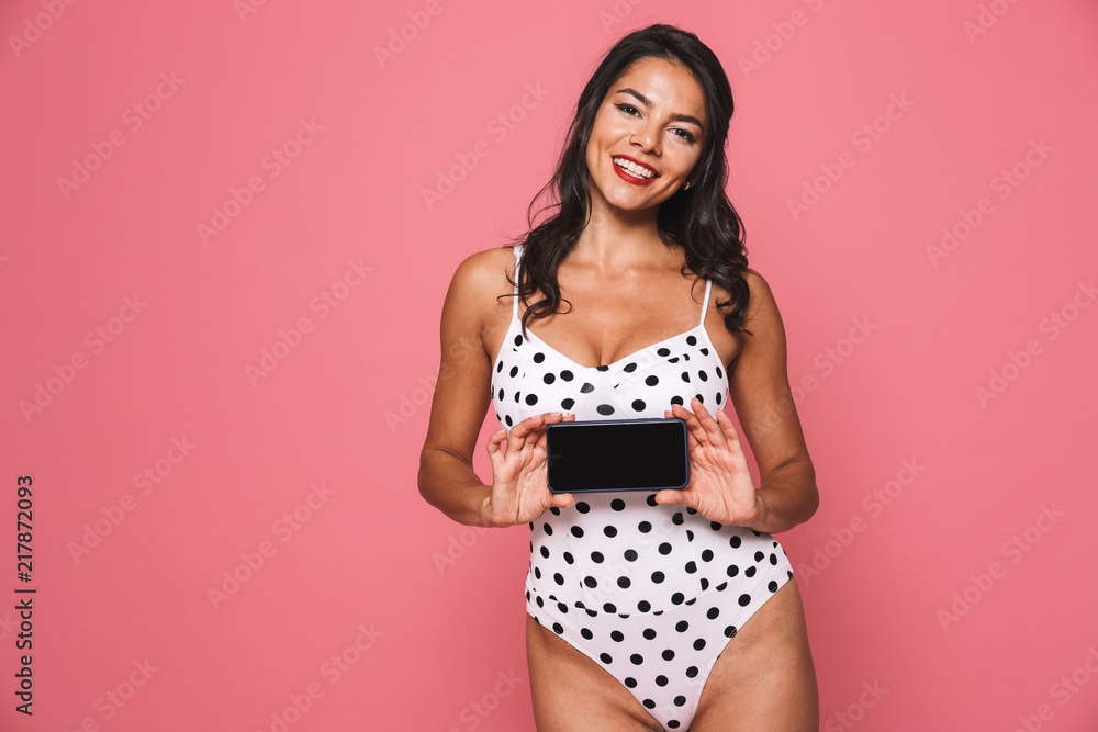 Sticker Cheerful woman in swimwear showing display of mobile phone.