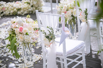Chair decorated with flowers in Wedding ceremony.