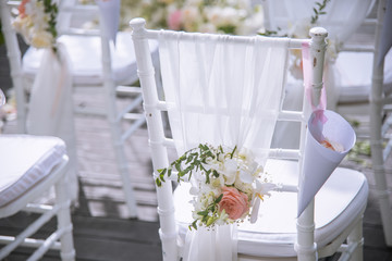 Chair decorated with flowers in Wedding ceremony.