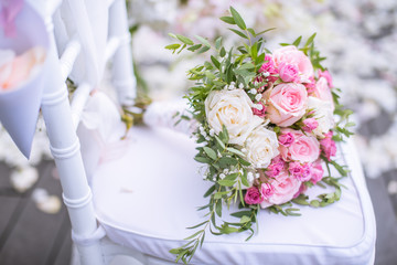 Chair decorated with flowers in Wedding ceremony.