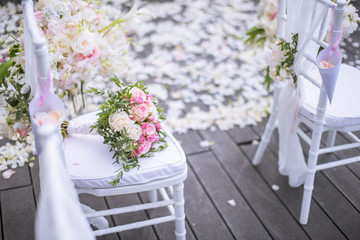 Chair decorated with flowers in Wedding ceremony.