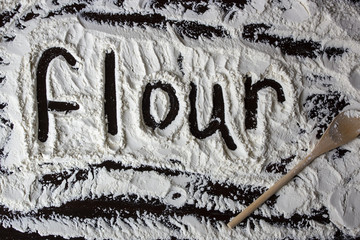 Flour word written on the flour on the table