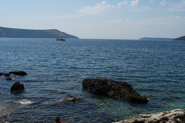 Rocky bay with giant boulders and wild herbs