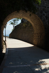 Old tunnel on a promenade walk constructed with cobblestone