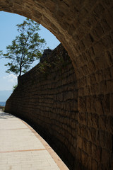 Old tunnel on a promenade walk constructed with cobblestone