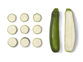 Zucchini collection. Whole half and sliced zucchini isolated on white background. Top view.
