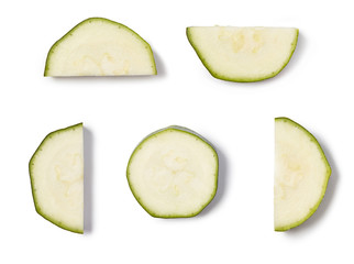 Slices of zucchini isolated on white background. Close up.