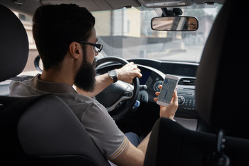 Man using mobile phone while driving.