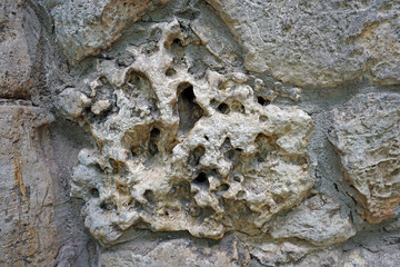 The wall of natural stones of different sizes.