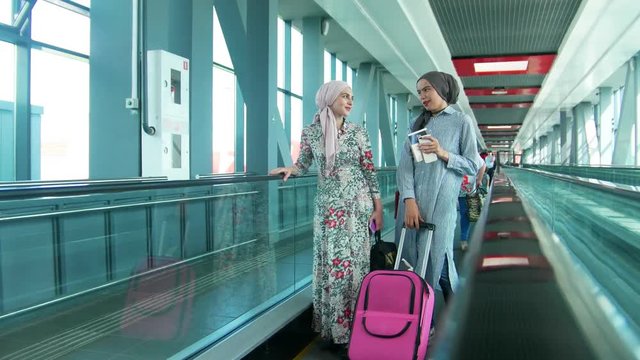 Two muslim women traveling in the railway station